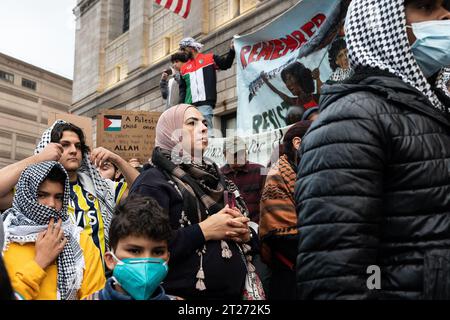 Pro-Palestine supporters listen to speakers during a rally in Boston. Pro-Palestine supporters organized a rally in Boston, Massachusetts. The protesters denounced Israel's response on the Gaza Strip following the Hamas attack at the music festival on October 7, 2023. Since then, Palestinian civilians in the Gaza Strip have been caught in the crossfire between Israeli air strikes. Stock Photo