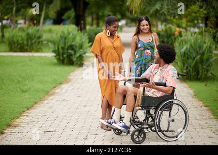 Diverse group of young people taking in city park Stock Photo