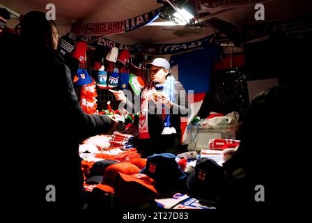 A street vendor sells merchandise ahead of the UEFA Euro 2024 qualifying match between England and Italy at Wembley Stadium, London. Picture date: Tuesday October 17, 2023. Stock Photo