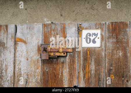 Rusty door latch with padlock Stock Photo