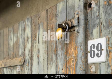 One garage door additionally secured with bolt and padlock Stock Photo