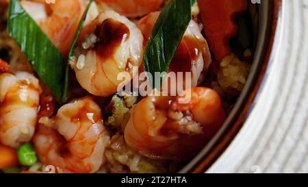 Fresh seafood recipe. Shrimp poke bowl with fresh prawn, brown rice, pickled sweet onion, radish, soy beans edamame Stock Photo