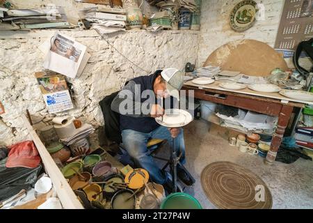 A Mexican craftsman hand paints ceramic plates at Gorky Gonzales pottery workshop in Guanajuato, Mexico. The workshop rescued traditional majolica pottery which had become lost to time. Stock Photo