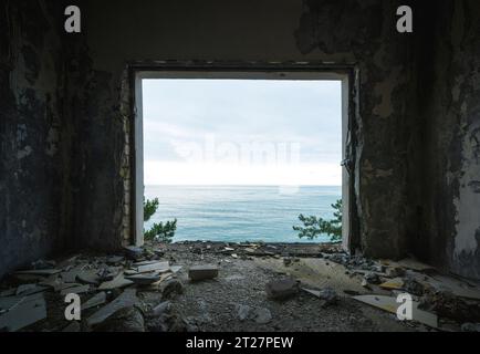 ruined apartment room with the sea window view Stock Photo