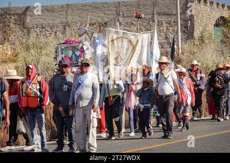 Catholic pilgrims walk down the road on their way to San Juan de Los Lagos near Sauceda, Guanajuato, Mexico. The annual month long pilgrimage draws more than a million Catholic faithful on a journey to the sacred site in Jalisco State. Stock Photo