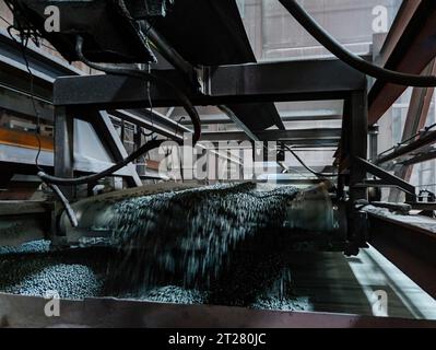 Industrial production line of Iron ore pellets in metallurgical factory. Stock Photo