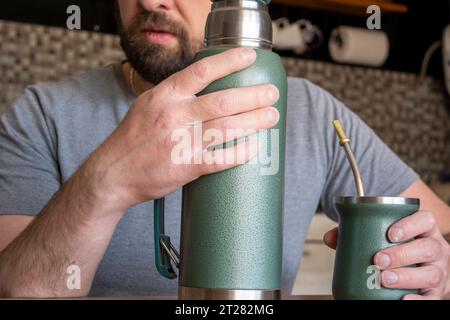 Young caucasian man drinking mate. Stock Photo