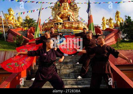 Ramkot, Nepal. 18th Aug, 2023. Nuns practicing Kung Fu outside the main temple of Druk Amitabha Mountain monastery on the outskirts of Kathmandu. The fans they hold appear like a normal fan but for self defense training it is equipped with a blade. (Credit Image: © Skanda Gautam/ZUMA Press Wire) EDITORIAL USAGE ONLY! Not for Commercial USAGE! Stock Photo