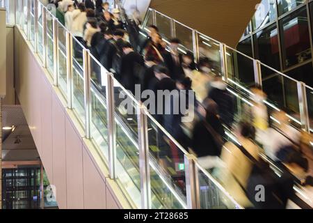 picture of crowds of people on an escalator leading to a subway station Stock Photo