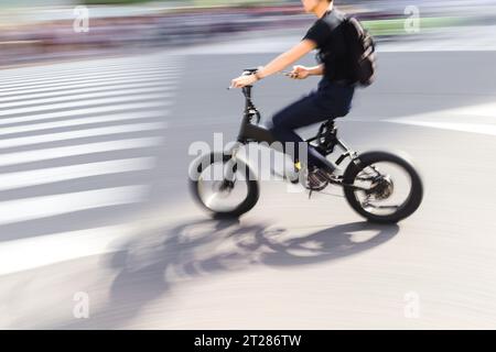 picture with motion blur of a young cyclist from delivery service who ...