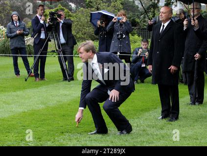 King Willem-Alexander of the Netherlands picks up the dart during the powhiri (maori welcome) at the official welcome at Government House, Wellington, New Zealand Stock Photo