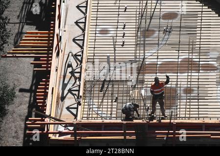 Aerial view of construction workers actively engaged on a construction site, helping the project move forward. Stock Photo