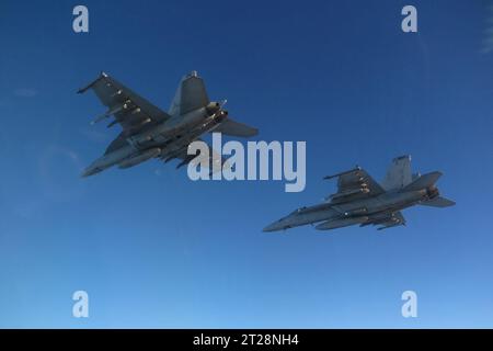 Mediterranean Sea. 11th Oct, 2023. An F/A-18F Super Hornet, left, attached to the Blacklions of Strike Fighter Squadron (VFA) 213, and an F/A-18E Super Hornet, attached to the Ragin Bulls of Strike Fighter Squadron (VFA) 37, conduct flight operations in the Eastern Mediterranean Sea, Oct. 11, 2023. VFA-213 and VFA-37 are deployed aboard the world's largest aircraft carrier USS Gerald R. Ford (CVN 78) as a part of Carrier Air Wing (CVW) 8. Gerald R. Ford is the U.S. Navy's newest and most advanced aircraft carrier, representing a generational leap in the U.S. Navy's capacity to project powe Stock Photo