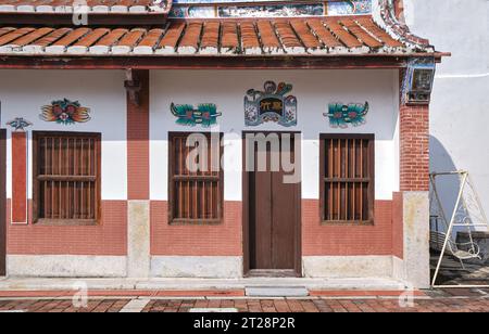 Vintage Chinese house in George Town, Penang. Chinese wording:(left to right:  living in harmony, longevity, Room-Fernleaf Bamboo, living in harmony) Stock Photo