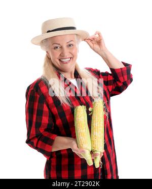 Mature female farmer with ripe corn cobs isolated on white background Stock Photo