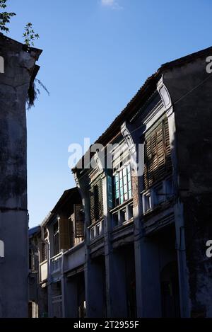 Heritage terrance house on blue sky background. Old street view in George Town Stock Photo