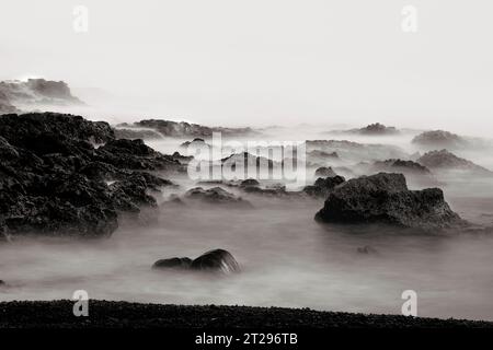 Waves hitting the rocks in the ocean Stock Photo