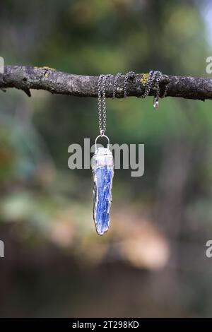 Raw kyanite pendant embraced by silver.  Gemstone with a strong calming effect on the whole being, it gives inner tranquility and peace, an energy amp Stock Photo