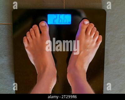 Help to lose kilograms with woman feet stepping on a weight scale Stock  Photo - Alamy