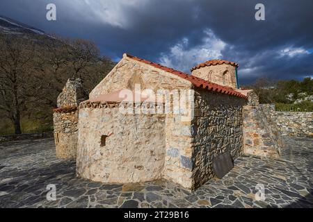 Agios Fotis Chapel, Agios Ioannis, Agios Yannis, stone old chapel, dark cloudy sky, Amari Basin, Amari, Rethimnon Province, Crete, Greece Stock Photo