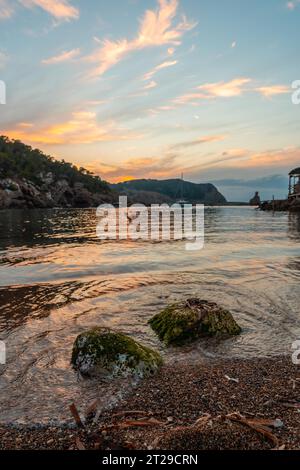 Long exposure on some rocks on the beach at sunset in Benirras in Ibiza. vacation concept Stock Photo