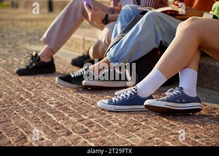 Legs of university students doing homework Stock Photo