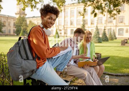 University students working on homework or creative project at campus outdoors Stock Photo