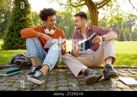 Two friend students talking together discussing ideas Stock Photo