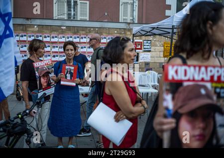 Tel Aviv, Israel. 18th Oct, 2023. Families and their supporters protest in front of the Kiriya military base, displaying photos of their kidnapped relatives. Credit: Ilia Yefimovich/dpa/Alamy Live News Stock Photo