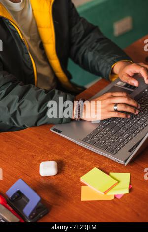 High angle of crop anonymous male remote worker using netbook for online project while working on hoffice at table Stock Photo