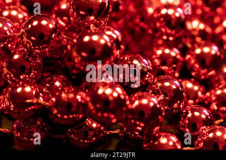 Red metallic balls. Christmas decoration garland. Close up. Selective focus Stock Photo