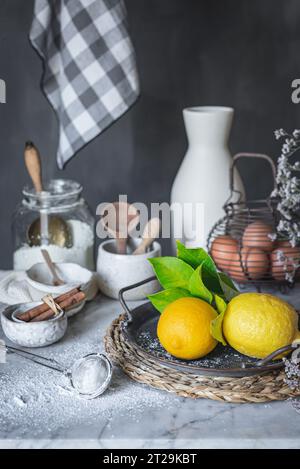 Ceramic bowls and vase near napkin placed on marble table against gray background at rustic kitchen Stock Photo