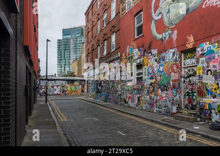 Graffiti and flyers on the walls around Brick Lane, London has become a tourist must see. Stock Photo