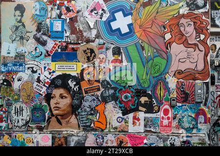 Graffiti and flyers on the walls around Brick Lane, London has become a tourist must see. Stock Photo