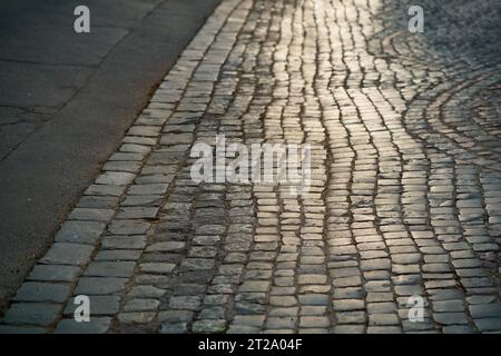 Stone pavement in perspective. Artistic texture and background. Element of the old street of the city of Lviv in Ukraine. Outdoor street design of the Stock Photo