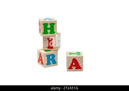Children's wooden cubes with blue, red and green letters in the shape of a tower stand one on top of the other and lie side by side. For text. Stock Photo