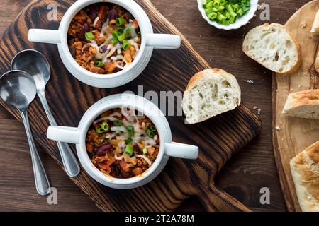 A top down view of crock bowls filled with homemade chili con carne. Stock Photo