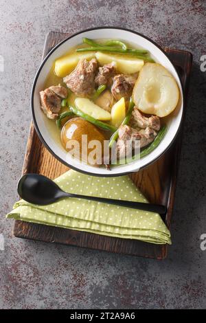 Swedish Lamb Stew with Pears Potatoes and Green Beans closeup on the plate on the table. Vertical top view from above Stock Photo