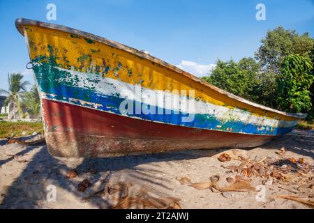 A colorful rustic boat resting on a lonely beach Stock Photo