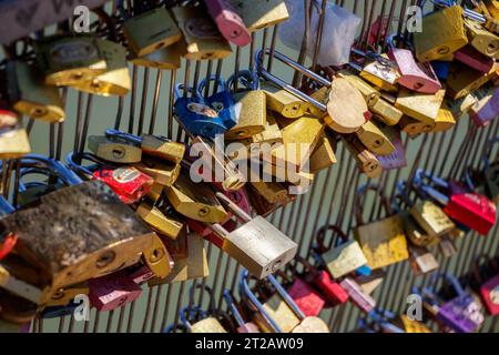 Engraved and marked padlocks hanging in the Pot Des Arts or Inlove ones bridge, hundreds of locks telling a lot of love stories, couples and families Stock Photo
