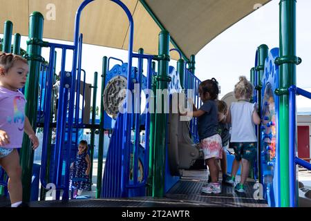 KSC Child Development Center (CDC) Playground Ribbon Cutting. Children enjoy a brand new playground at Kennedy Space Center’s Child Development Center on Aug. 10, 2023. The playground officially opened following a ribbon cutting ceremony earlier in the day. Stock Photo