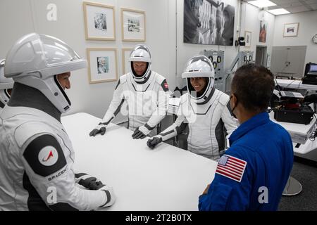 NASA’s SpaceX Crew-7 Live Launch Coverage. NASA’s SpaceX Crew-7 crew members Jasmin Moghbeli, Andreas Mogensen, Satoshi Furukawa, and Konstantin Borisov play a traditional card game on Saturday, Aug. 26, 2023, inside the suit-up room in the Neil Armstrong Operations and Checkout Building at NASA’s Kennedy Space Center in Florida. Next, they will get into the customized Tesla Model X vehicles that will transport them to Kennedy’s Launch Complex 39A. SpaceX’s Dragon spacecraft, powered by the company’s Falcon 9 rocket, will carry the four-person crew to the International Space Station as part of Stock Photo