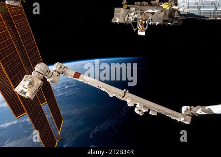 . iss069e085991 (Sept. 5, 2023) --- The International Space Station soars 266 miles above the coast of Argentina near the Rio de la Plata as it flies into an orbital sunset. In the foreground from left are, the station's main solar arrays, the Canadarm2 robotic arm, and the Kibo laboratory module's external platform. Stock Photo