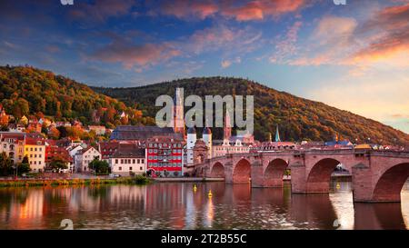 Heidelberg, Germany. Cityscape image of historical city of Heidelberg, Germany with Old Bridge Gate at beautiful autumn sunset. Stock Photo