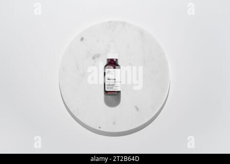 Strasbourg, France - September 2023: The Ordinary skincare brand by Deciem. AHA BHA Peeling Solution on marble circle white background. Clean minimali Stock Photo