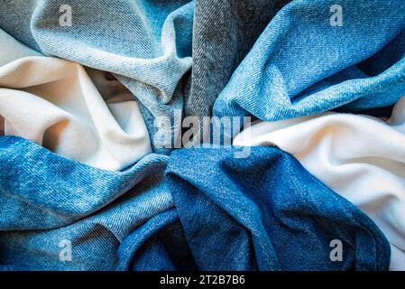 Various shades and colors of denim fabrics. Denim texture background. Stock Photo