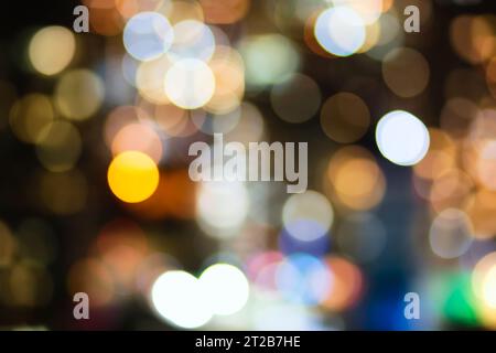 Defocused bright circular bokeh photograph of busy city random street lights at night Stock Photo