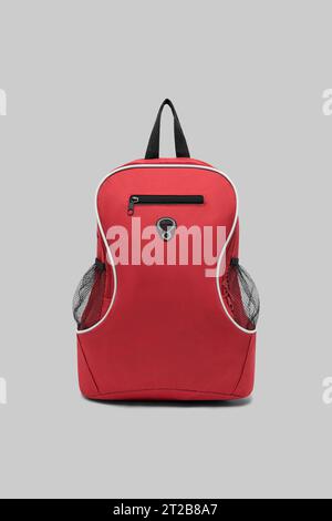 close up trendy fashionable school backpack red color isolated on white background with clipping path. front view shoulder strap bag. Stock Photo