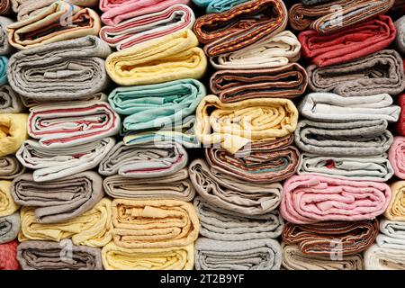 Colorful background of wrapped textiles, closeup fabric picture Stock Photo