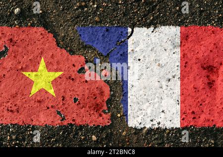 On the pavement are images of the flags of Vietnam and France, as a symbol of confrontation. Conceptual image. Stock Photo